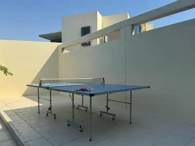 a ping pong table sitting on top of a patio at Oraya - Brand New Luxurious 3BR plus 2M Villa in Maple 2 in Dubai