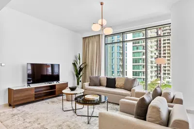 a living room with a couch and a tv at Luxurious Living in the heart of Emaar Beachfront in Dubai