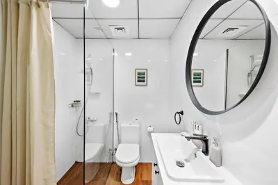a bathroom with a toilet and a sink and a mirror at StoneTree - Furnished 1BR in JLT with Lake View in Dubai