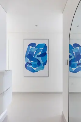 a painting on a wall in a white room at Creek Beach Roomy 3BR + terrace in Dubai