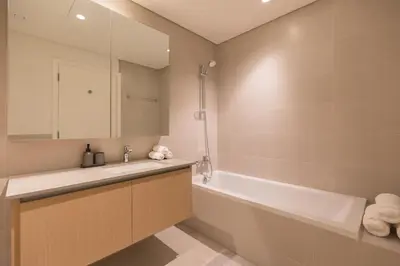 a bathroom with a sink and a bath tub at Creek Beach Roomy 3BR + terrace in Dubai