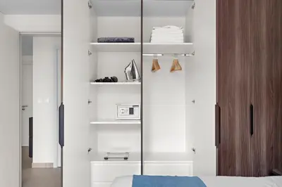 a bedroom with a bed and a glass door with a microwave at StoneTree - Luxury 1BR - Best Location for Tourist in Dubai