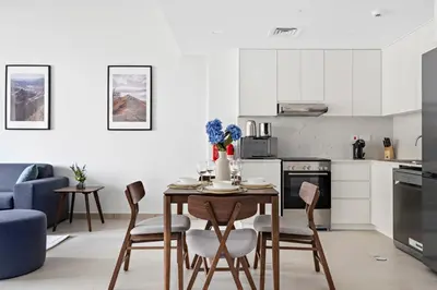 a kitchen with a table and chairs in a room at StoneTree - Luxury 1BR - Best Location for Tourist in Dubai