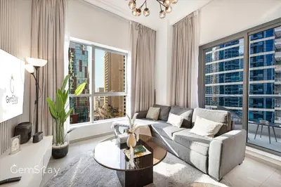 a living room with a couch and a table at Your Cosy Marina Retreat in Dubai