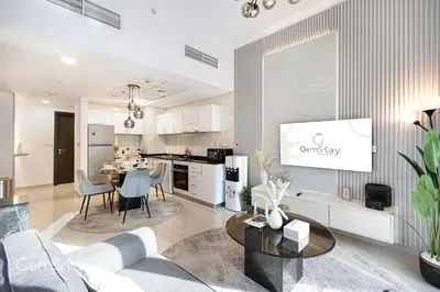 a living room with a couch and a table at Your Cosy Marina Retreat in Dubai