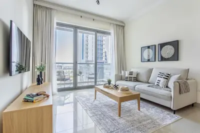 a living room with a couch and a table at Frank Porter - Fairview Residency in Dubai