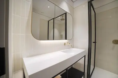 a bathroom with a white sink and a mirror at Studio with Burj Khalifa View - Upside Living in Dubai