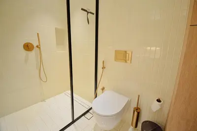 a bathroom with a shower with a toilet and a shower at Studio with Burj Khalifa View - Upside Living in Dubai