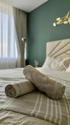 a towel laying on top of a bed at LUXURY SPACIOUS - 1 BR - SKY GARDENS DIFC - Heart of Trade Centre and Dubai Mall in Dubai