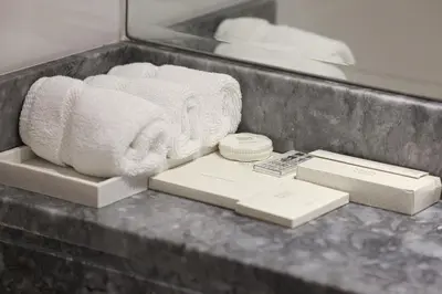 a counter top with towels and boxes on it at Visionary Vista: 2BR Al Habtoor City in Dubai