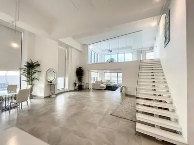 a living room with a staircase in a house at Rimal 3 - Incredible Two Bedroom in Dubai