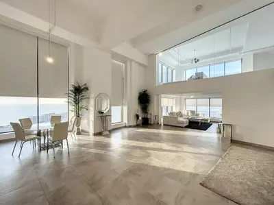a large living room with a table and chairs at Rimal 3 - Incredible Two Bedroom in Dubai