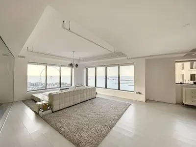 a large white living room with a couch and a rug at Rimal 3 - Incredible Two Bedroom in Dubai