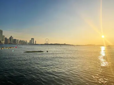 a large body of water with a city in the background at Seven Palm, Private beach, Infinity Pool, High Floor 3BDR in Dubai