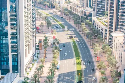 an aerial view of a street with palm trees and buildings at Stayis -1 BR Burj Khalifa View Partial in Dubai