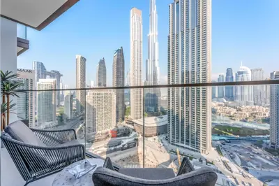 a balcony with two chairs and a view of a city at Stayis -1 BR Burj Khalifa View Partial in Dubai