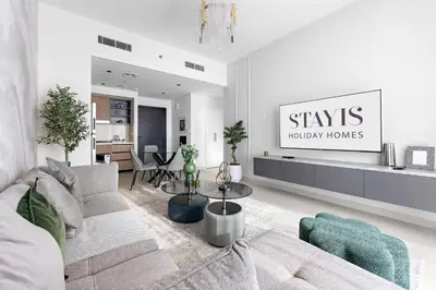 a living room with a couch and a table at Stayis -1 BR Burj Khalifa View Partial in Dubai