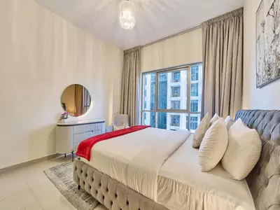 a bedroom with a large bed and a window at Golden Homes Boulverd Central 1BHK BLUE HEAVEN Near Dubai mall & burj khalifa Downtown Dubai in Dubai