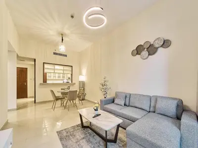 a living room with a couch and a table at Golden Homes Boulverd Central 1BHK BLUE HEAVEN Near Dubai mall & burj khalifa Downtown Dubai in Dubai