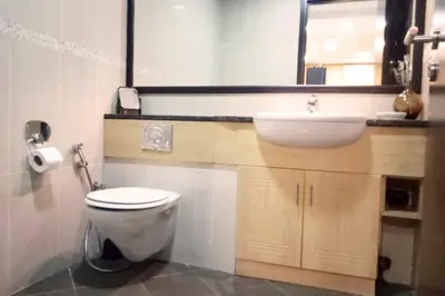 a bathroom with a sink and a toilet and a mirror at Full lake View 1bk Apartment in JLT 4 ppl early & late check in 10mn to Marina metro station in Dubai