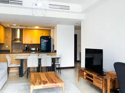 a living room with a couch and a table with a tv at Full lake View 1bk Apartment in JLT 4 ppl early & late check in 10mn to Marina metro station in Dubai