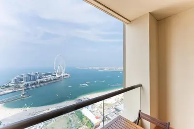 a balcony with a view of the ocean at JBR High Floor 2 Bed with full Al Ain View in Dubai