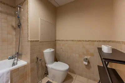 a bathroom with a toilet and a sink and a tub at JBR High Floor 2 Bed with full Al Ain View in Dubai