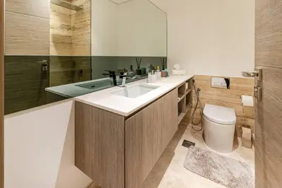 a bathroom with a sink and a toilet and a tub at Designer Glam Studio Steps from Burj Khalifa in Dubai