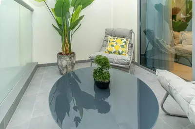 a living room with a table and a chair at Designer Glam Studio Steps from Burj Khalifa in Dubai
