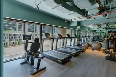 a gym with a row of treadms and cardio machines at Designer Glam Studio Steps from Burj Khalifa in Dubai