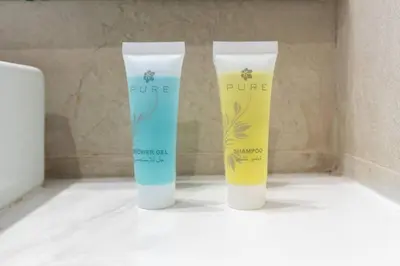 a couple of bottles of moisturizers sitting on a counter at Studio 12min from Burj Khalifa - Azizi Riviera 32 - Dubai in Dubai