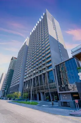 a tall building with many windows in a city at Luxury Glam Studio Near Burj Khalifa Downtown in Dubai
