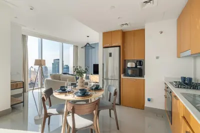 a kitchen and dining room with a table and chairs at GuestReady - Above the clouds at Opera Grand in Dubai