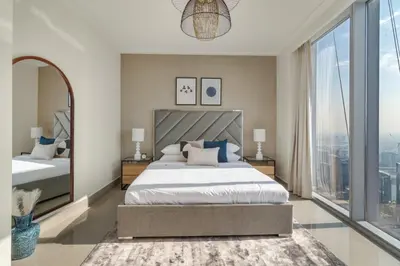 a bedroom with a large bed and a large window at GuestReady - Above the clouds at Opera Grand in Dubai