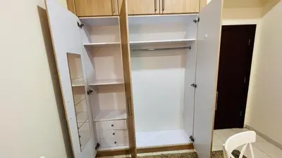 a closet with white shelves and a mirror at Master Room with attach Bathroom Near Mall of the Emirates in Dubai