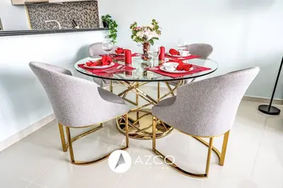 a dining room with a glass table and chairs at 1BR Apartment in Paramount Midtown in Dubai