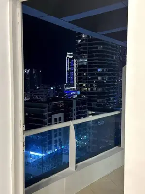 a view of a city skyline at night from a window at Dubai Marina (Marina Diamond 2) 1 Bedroom Apt. in Dubai