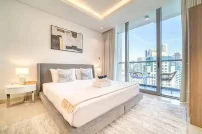 a bedroom with a large bed and a large window at Canal-View Serenity: Modern Studio in Sterling in Dubai