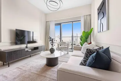 a living room with a couch and a tv at Silkhaus Luxurious 1 BDR Stunning View in Dubai