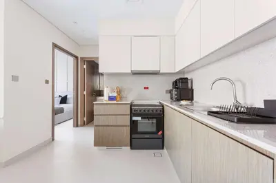 a kitchen with a sink and a stove top oven at Silkhaus Luxurious 1 BDR Stunning View in Dubai