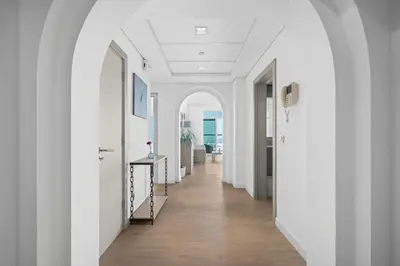 an arched hallway with white walls and wood floors at Seaview-Shoreline4-Palm Jumeirah in Dubai