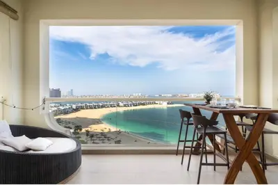 a dining room with a view of a beach at Seaview-Shoreline4-Palm Jumeirah in Dubai