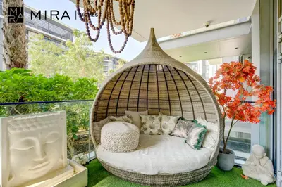 a hanging basket bed with pillows at Mira Holiday Homes - Luxury 1 bedroom in Bluewaters Island in Dubai