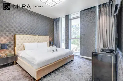 a bedroom with a bed and a television in it at Mira Holiday Homes - Luxury 1 bedroom in Bluewaters Island in Dubai