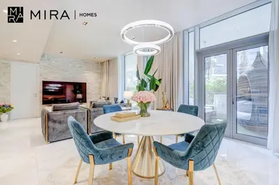 a dining room with a table and chairs at Mira Holiday Homes - Luxury 1 bedroom in Bluewaters Island in Dubai