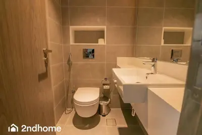 a bathroom with a toilet and a sink at 2ndHome - District One Residences , Residence 14 in Dubai