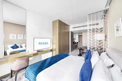 a bedroom with a large bed with a blue blanket at ALiving Deluxe Studio I DAMAC Maison Prive, Business Bay -1204 in Dubai