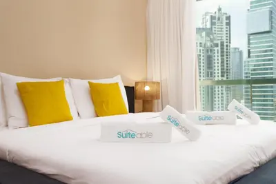 a white bed with price signs on top of it at Discover unmatched Comfort in Downtown Dubai in Dubai