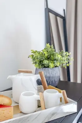 a tray with white cups on a table at Frank Porter - Noor 3 Midtown in Dubai