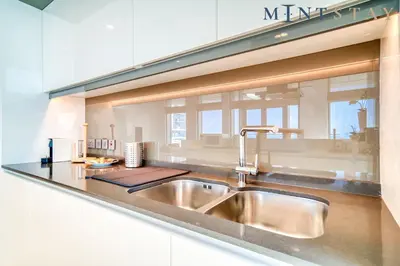 a kitchen with a sink and a counter top at Bluewaters Residences 5, Bluewaters Island - Mint Stay in Dubai